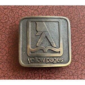 Vintage 1975 art studio Yellow Pages brass belt buckle